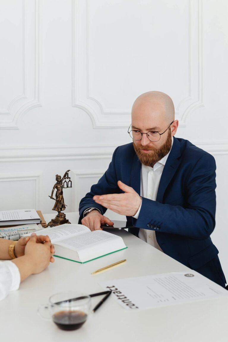 Never Run Out of Ideas: Top Tips for Generating Fresh Blog Topics 4 Man in suit consulting with client in elegant office, discussing documents on desk.